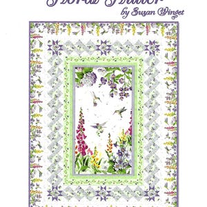 May include: A floral quilt with the text "Floral Flutter" by Susan Winget. The quilt features a central panel with hummingbirds and flowers, surrounded by a border of floral and geometric patterns. The throw quilt measures 54.5" x 72.5".