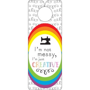 May include: A rainbow-colored door hanger with a sewing machine silhouette and the text "I'm not messy, I'm just CREATIVE".