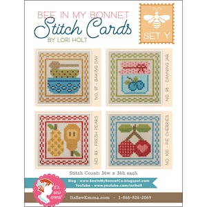 May include: A craft kit titled "Bee in My Bonnet Stitch Cards" by Lori Holt. The image shows four cross-stitch designs: a bowl with a spoon, a jar of blueberries, two pears, and cherries. The kit includes a bee stamp and the text "Set Y".