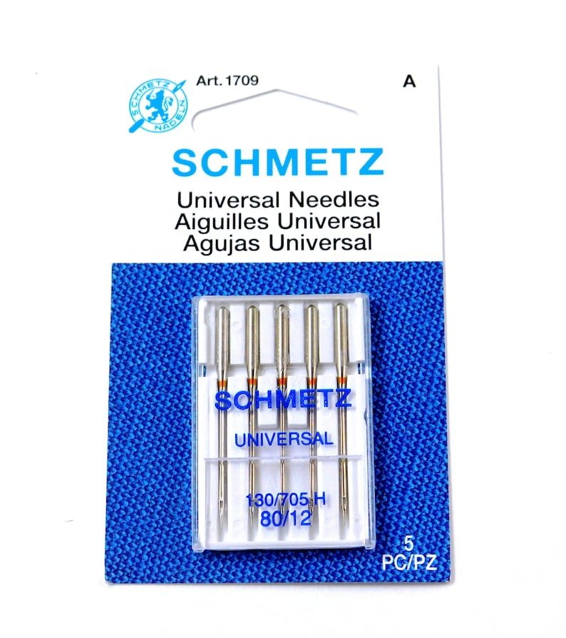 May include: A pack of 5 Schmetz Universal sewing machine needles in a clear plastic case. The needles are size 130/705 H, 80/12. The packaging is blue and white with the Schmetz logo and the text "Universal Needles, Aiguilles Universal, Agujas Universal".