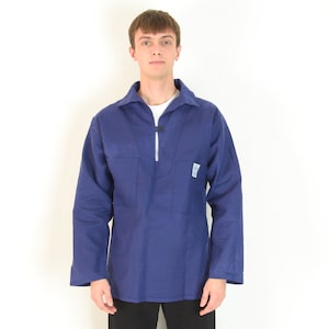 May include: A navy blue work shirt with a white zipper and two front pockets. The shirt has long sleeves and a collar. A small patch is visible on the right side of the shirt.