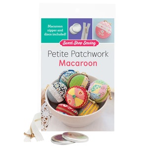 May include: A book titled "Petite Patchwork Macaroon" by Sweet Shop Sewing. The book cover features a white bowl filled with colourful fabric macaroons. The book includes a zipper and discs for making the macaroons.