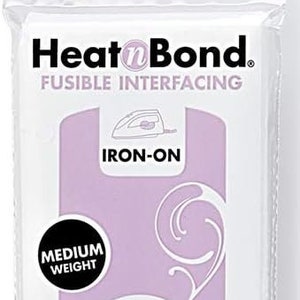 May include: HeatnBond fusible interfacing, iron-on for shirts, collars, and buttonholes. The package is white with a lavender center and features the text "Medium Weight". Measures 50.8cm x .91m.