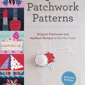 May include: Book cover featuring 318 patchwork patterns and applique designs by Kumiko Fujita. The cover is a light beige with a red and white polka dot fabric and a blue circle with the text "ENGLISH EDITION".