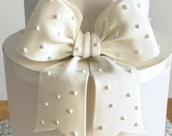 Big white fondant bow with pearl dots