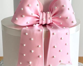 Big light pink fondant bow with pearl dots