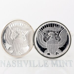 May include: A pair of silver cufflinks featuring a detailed design of the American bald eagle with the words "E Pluribus Unum" on the shield. The cufflinks are a classic and elegant accessory for any man's wardrobe.