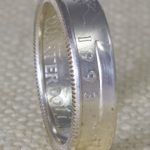 May include: Silver ring made from a 1993 US dollar coin. The ring is made from the outer edge of the coin, with the year 1993 visible on the side.