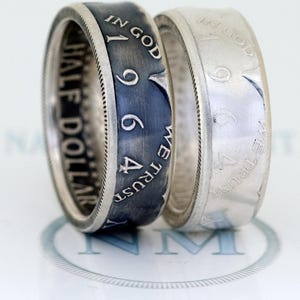 May include: Two silver rings made from US dollar coins. The ring on the left is oxidized and the ring on the right is polished.