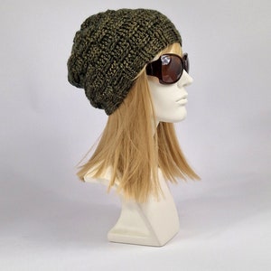 May include: A green knitted beanie with a slouchy fit. The beanie is made with a textured stitch pattern and has a subtle sheen.