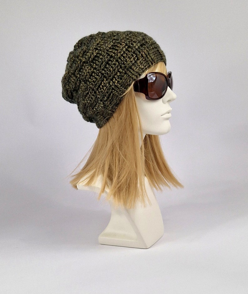 May include: A green knitted beanie with a slouchy fit. The beanie is made with a textured stitch pattern and has a subtle sheen.