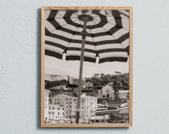 Black and white art photography print of buildings and parasols on the beach in Sestri Levante, Italy.