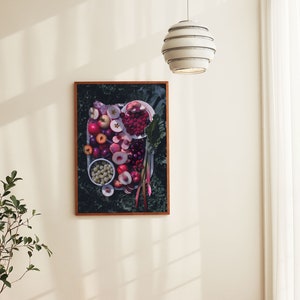 May include: A framed print of a still life featuring a variety of red and pink fruits, including apples, cherries, and plums, arranged on a plate with green leaves.