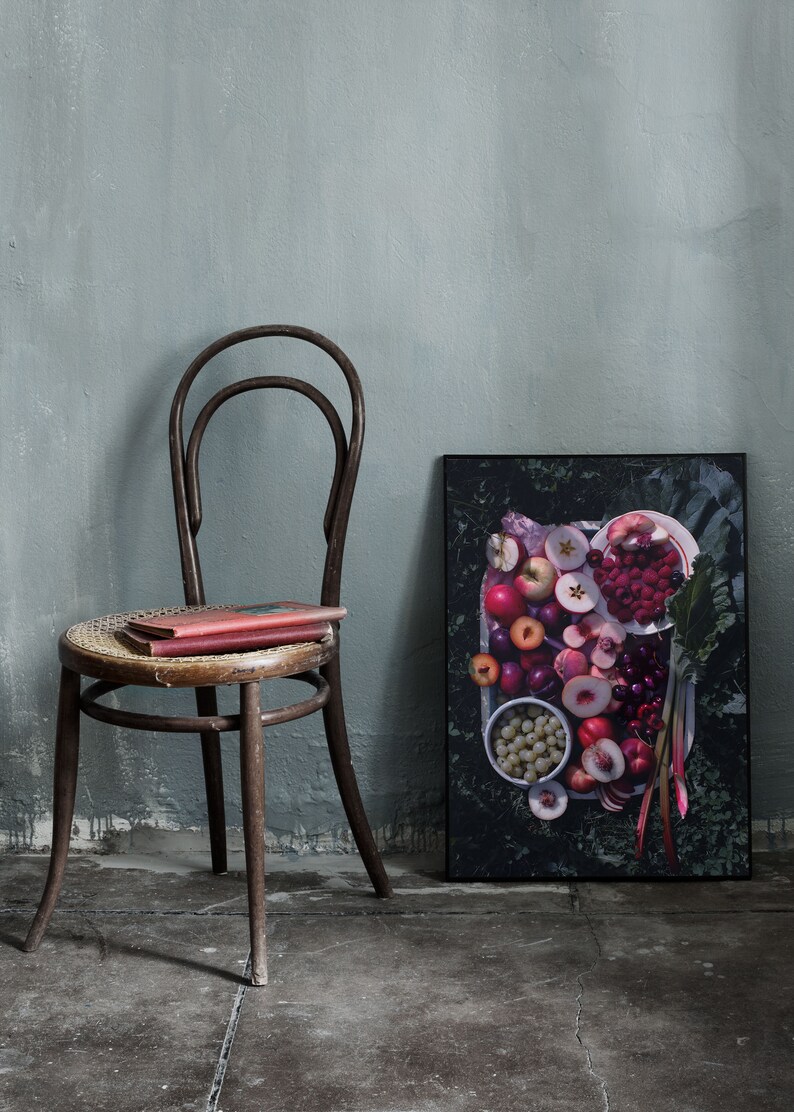 May include: A framed print of a still life featuring a variety of fresh fruit, including peaches, plums, cherries, and raspberries, arranged on a white plate with green leaves and rhubarb stalks.