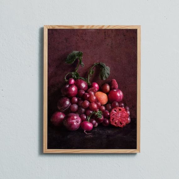 Grapes, apricot, radishes, plums, raspberries and a tomato.