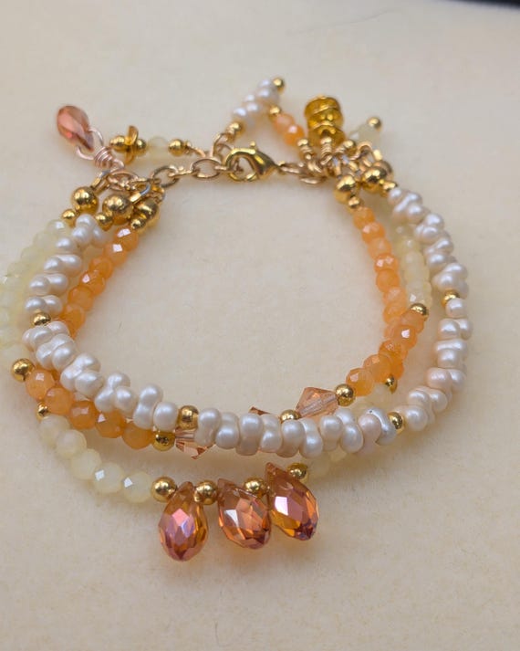 Yellow and Orange Crystal Three Strand Bracelet With Glass Pearl Peanut Beads and Crystal Dangles