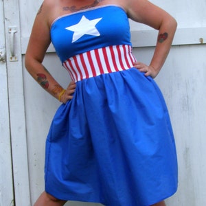 May include: A blue strapless dress with a white star and red and white stripes around the waist.