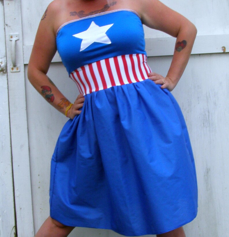 May include: A blue strapless dress with a white star and red and white stripes around the waist.