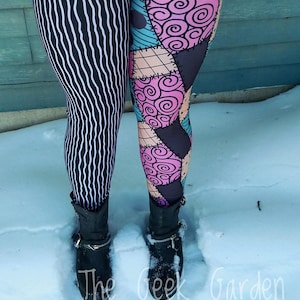 May include: Leggings with a split design: one leg features black and white vertical stripes, the other has a patchwork pattern in pink, teal, and tan. The leggings are worn with black ankle boots. The Geek Garden is printed on the bottom.