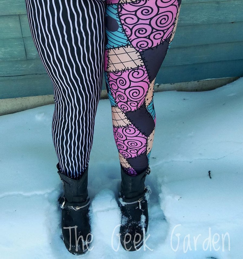 May include: Leggings with a split design: one leg features black and white vertical stripes, the other has a patchwork pattern in pink, teal, and tan. The leggings are worn with black ankle boots. The Geek Garden is printed on the bottom.
