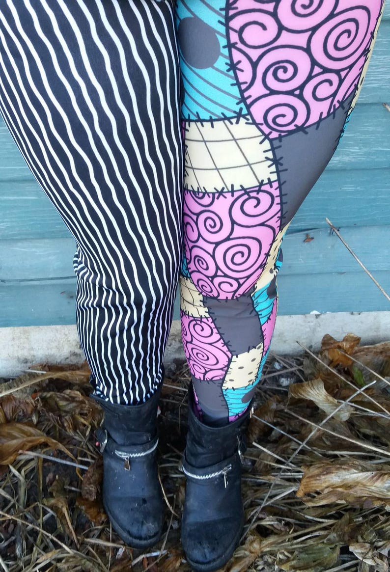 May include: Leggings with two different patterns. One leg features black and white vertical stripes, while the other has a patchwork design in pink, blue, gray, and beige. Black ankle boots with zippers complete the look.
