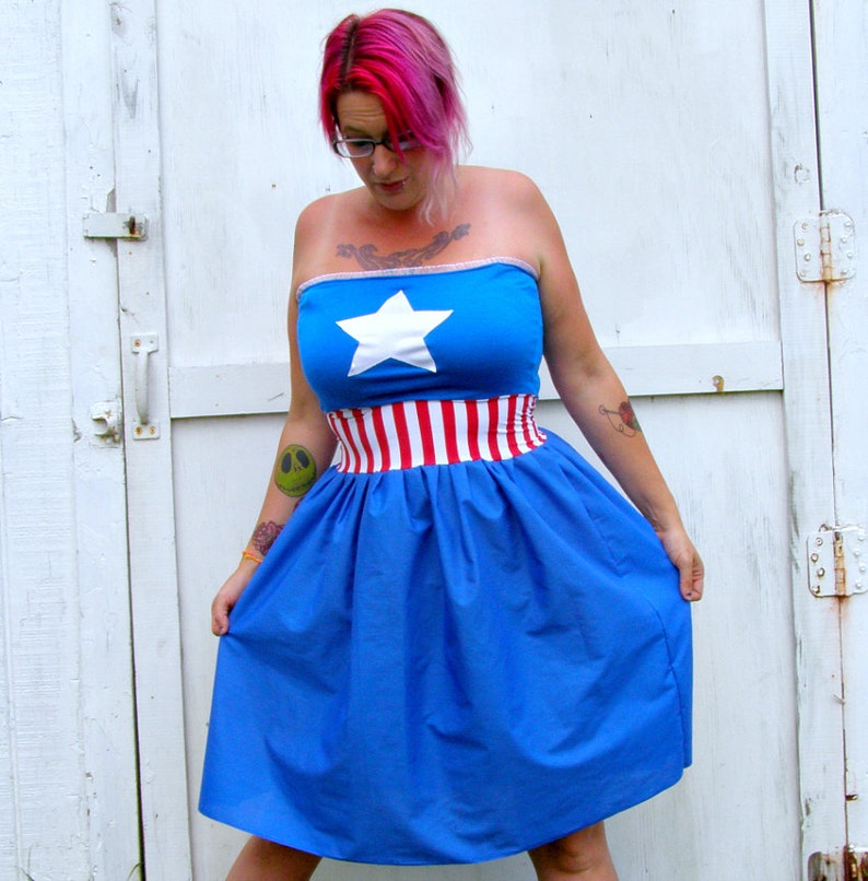 May include: A blue and red strapless dress with a white star and red and white stripes. The dress is made of a soft, flowing fabric and has a full skirt.
