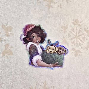 May include: A sticker featuring a cartoon elf with brown hair wearing a red and white hat and holding a box with two small dogs inside. The elf is smiling and the dogs are looking at the viewer.