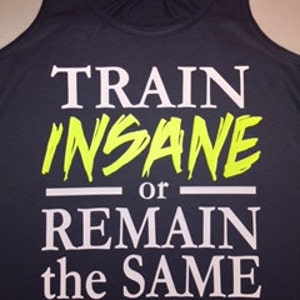 May include: A navy blue tank top with the text "TRAIN INSANE or REMAIN the SAME" in white and neon green lettering.