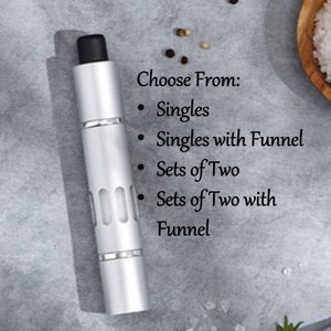 May include: A silver and black pepper grinder with a choice of options: singles, singles with funnel, sets of two, and sets of two with funnel.
