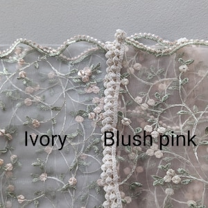 May include: Close-up of two sections of delicate floral lace. One section is ivory, the other is blush pink. Both feature embroidered flowers and leaves in soft colors. The text "Ivory" and "Blush pink" are visible.