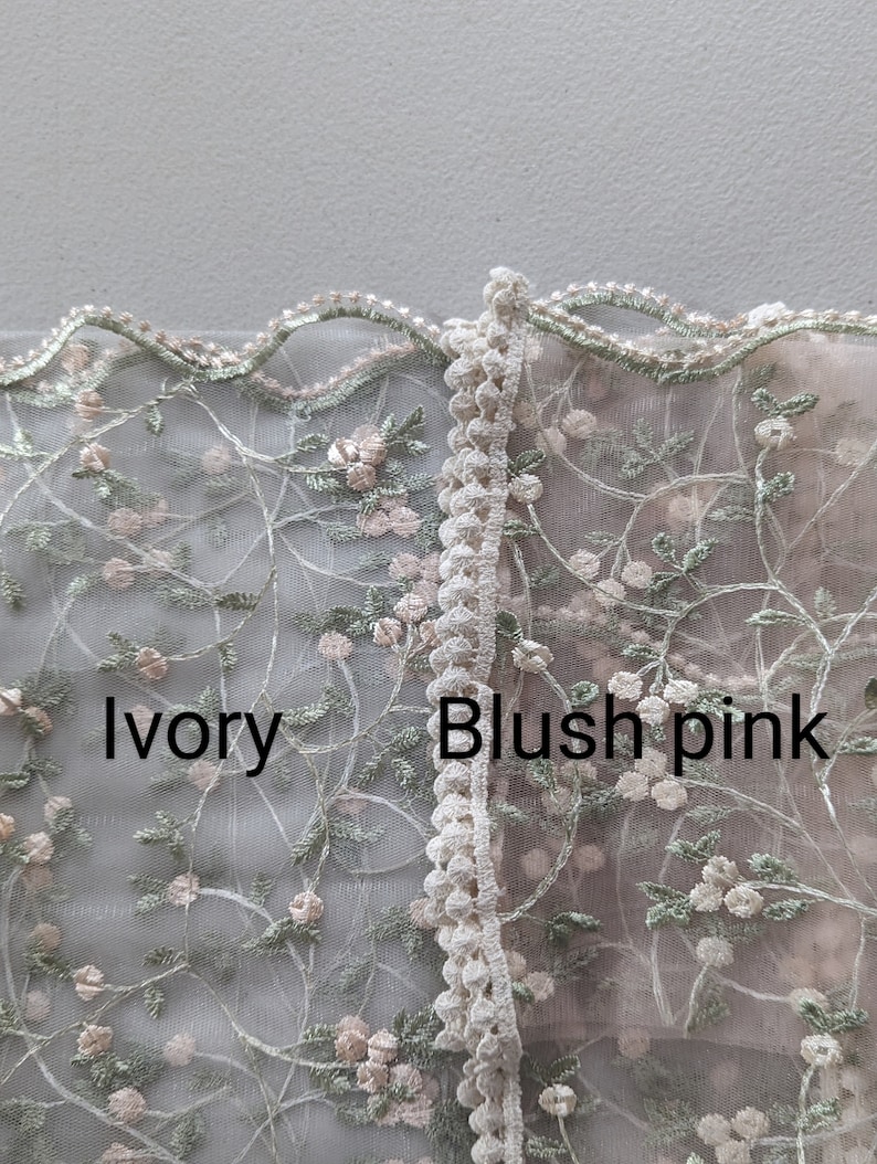 May include: Close-up of two sections of delicate floral lace. One section is ivory, the other is blush pink. Both feature embroidered flowers and leaves in soft colors. The text "Ivory" and "Blush pink" are visible.