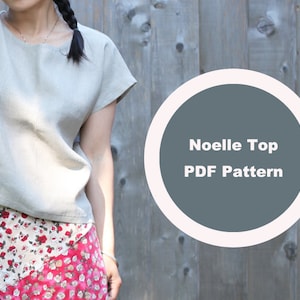 May include: A light beige linen top with short sleeves. The top is paired with a floral print skirt. A circular graphic with the text "Noelle Top PDF Pattern" is on the right side of the image.