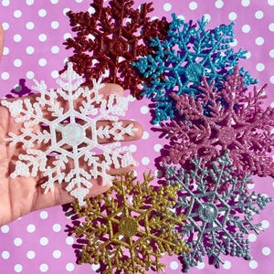 Glitter snowflake hair clip fascinator in pink blue silver gold and white