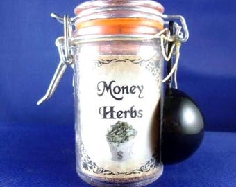 May include: A clear glass jar with a metal wire bail closure and an orange rubber seal. The label features the text Money Herbs above an illustration of a bag with a dollar sign. A small black measuring scoop is attached to the side of the jar.