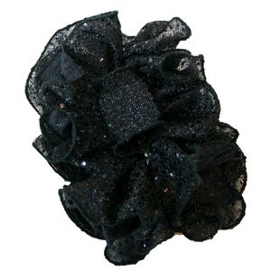 May include: A black sparkly hair scrunchie made of fabric with a ruffled design.