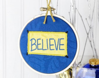 Believe Sign Ornament: Handmade small embroidery hoop art with motivational quote. Desk, office, or Christmas Tree decoration.