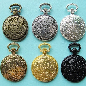 May include: Six antique-style pocket watch pendants in various metallic finishes: bronze, silver, and gold. Each watch has a detailed floral design on the front and a loop for attaching to a chain or necklace. One watch is black.