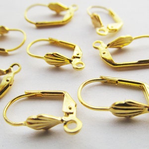 May include: Gold-toned earring hooks with a scalloped design. The hooks are made of metal and have a spring-loaded closure.