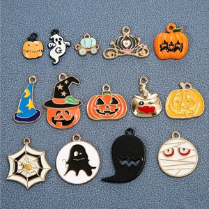 May include: Assortment of Halloween-themed charms featuring pumpkins, ghosts, witches, spiders, and mummies. The charms are made of metal and have a gold finish.