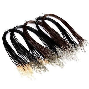 May include: A bulk pack of 20 black and brown leather cord necklaces with silver and gold lobster clasps.