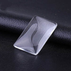 Puede incluir: Una cúpula de vidrio rectangular transparente, perfecta para exhibir objetos pequeños o crear un terrario en miniatura.