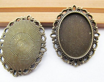 May include: Two antique gold oval-shaped metal frames with intricate designs. The frames are perfect for adding a vintage touch to jewelry making projects.