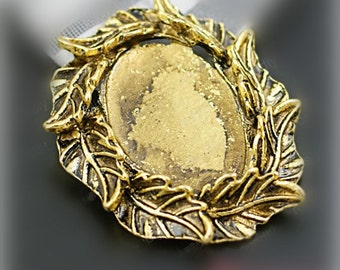 May include: Gold-toned metal pendant with a decorative leaf design. The pendant has a blank oval space in the center, perfect for adding a cameo or other embellishment.