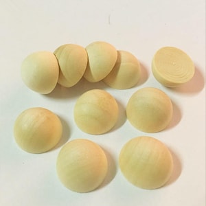 May include: A set of ten unfinished wooden half-dome shapes. The half-domes are a light beige color and are arranged in a semi-circle.