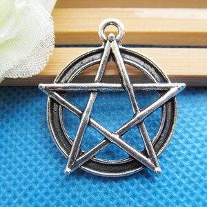 May include: Silver-toned metal pendant charm featuring a pentagram design with a circle around it.