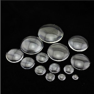 Peut inclure: Assortiment de cabochons en verre transparent de diff&eacute;rentes tailles, parfaits pour la cr&eacute;ation et la fabrication de bijoux.