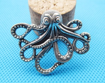 May include: Silver-toned octopus charm with a detailed design. The octopus has eight tentacles with a beaded texture.