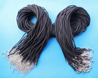 May include: A bundle of 50 black suede cord necklaces with silver lobster clasps. Each cord is approximately 18 inches long.