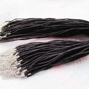 May include: A bulk pack of 50 black waxed cotton cords with silver lobster clasps. The cords are approximately 18 inches long and are ideal for making necklaces, bracelets, or other jewellery.