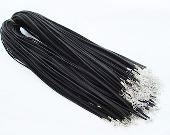 May include: A bulk pack of 50 black leather cord necklaces with silver lobster clasps. Each cord is approximately 18 inches long.